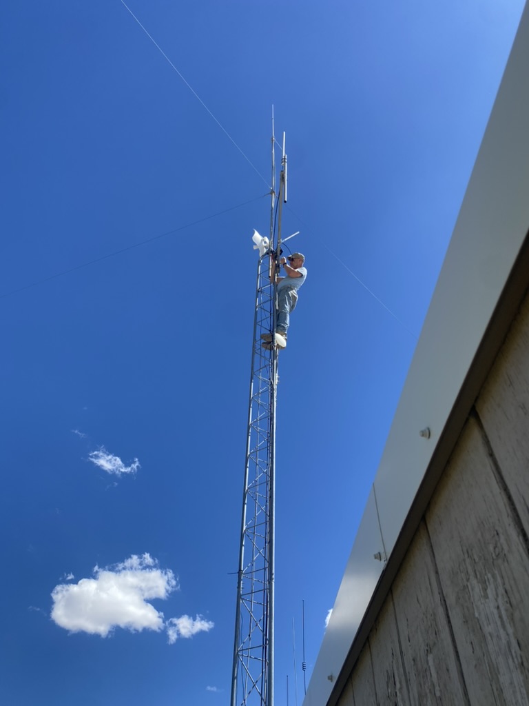 Phil climbing the ROG lattice tower to mount the mesh node