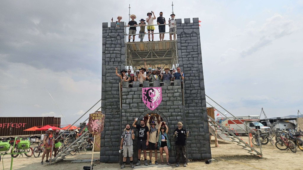 Burning Mesh community at Long Neck Tavern, volunteers on three levels of a playa castle holding up mesh radios