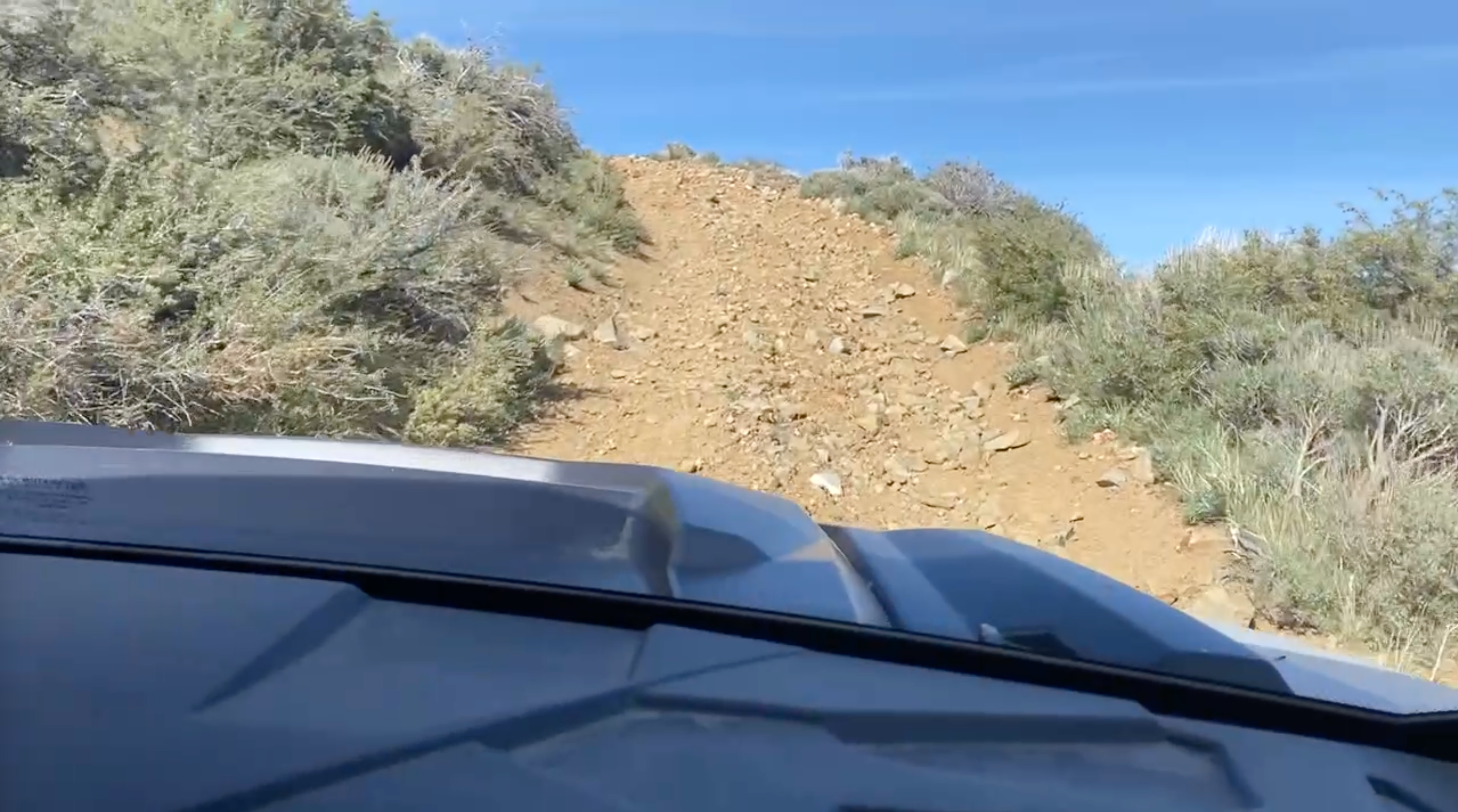 Steep rocky stretch of the Cross Three trail from the side-by-side